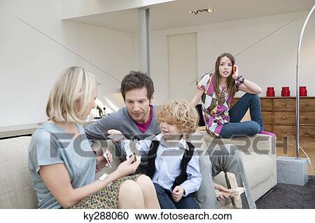 Family in a living room View Large Photo Image Stock Image - Family in a living room. Fotosearch