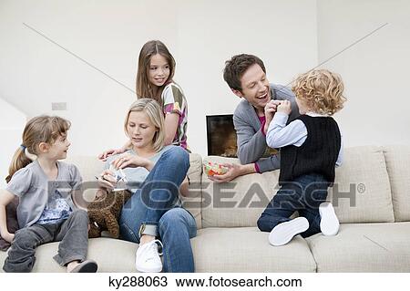 Family in a living room View Large Photo Image Stock Image - Family in a living room. Fotosearch
