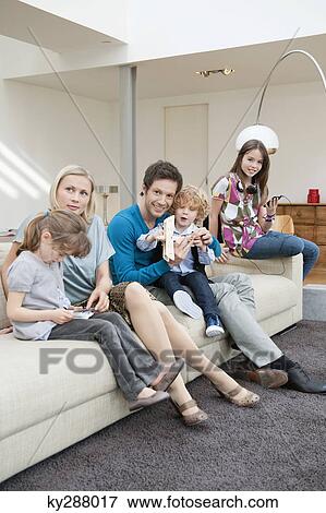 Family in a living room View Large Photo Image Stock Photo - Family in a living room. Fotosearch
