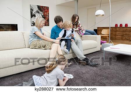 Family in a living room View Large Photo Image Stock Photo - Family in a living room. Fotosearch