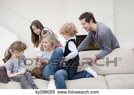 Family in a living room View Large Photo Image Stock Photo - Family in a living room. Fotosearch