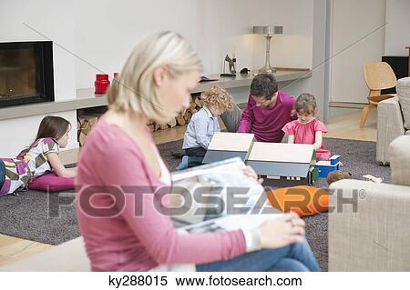 Stock Photography - Family in a living room. Fotosearch