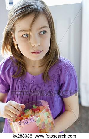 Girl holding a box full of gum drops View Large Photo Image Stock Photograph - Girl holding a box full of gum drops. Fotosearch