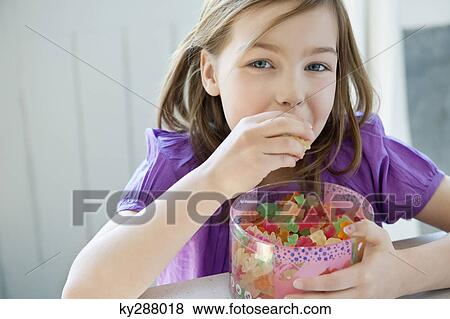 Portrait of a girl eating gum drops View Large Photo Image Stock Photo - Portrait of a girl eating gum drops. Fotosearch