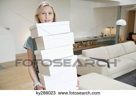 Portrait of a woman carrying shoe boxes View Large Photo Image Stock Image - Portrait of a woman carrying shoe boxes. Fotosearch