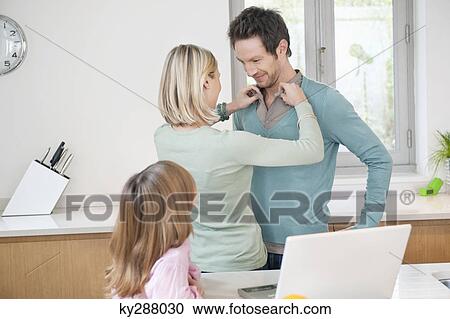 Woman adjusting shirt of her husband View Large Photo Image Stock Image - Woman adjusting shirt of her husband. Fotosearch