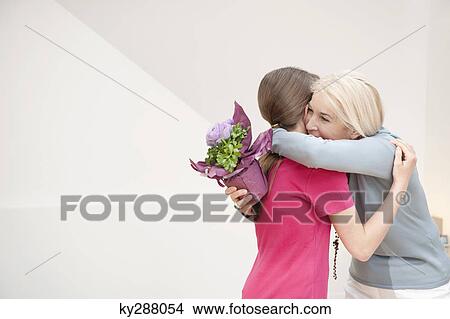Woman hugging her granddaughter View Large Photo Image Picture - Woman hugging her granddaughter. Fotosearch