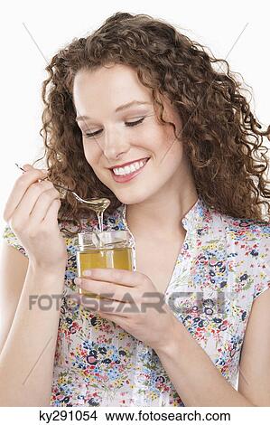 Close-up of a woman eating honey View Large Photo Image Picture - Close-up of a woman eating honey. Fotosearch