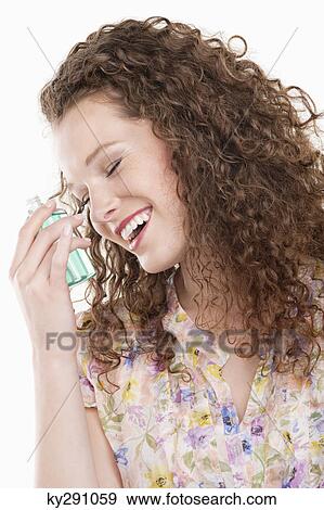 Close-up of a woman holding a bottle of aromatherapy oil View Large Photo Image Stock Photo - Close-up of a woman holding a bottle of aromatherapy oil. Fotosearch
