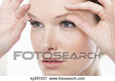 Close-up of a woman rubbing eyebrows View Large Photo Image Stock Image - Close-up of a woman rubbing eyebrows. Fotosearch