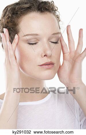 Close-up of a woman rubbing temples View Large Photo Image Stock Image - Close-up of a woman rubbing temples. Fotosearch
