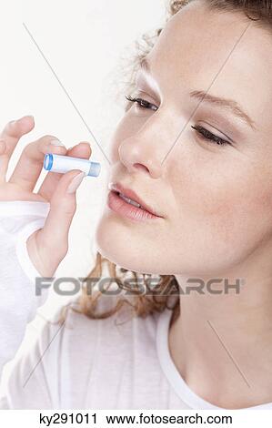 Close-up of a woman taking Homeopathic medicine View Large Photo Image Stock Image - Close-up of a woman taking Homeopathic medicine. Fotosearch