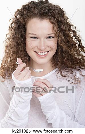 Portrait of a woman eating yogurt View Large Photo Image Stock Photography - Portrait of a woman eating yogurt. Fotosearch