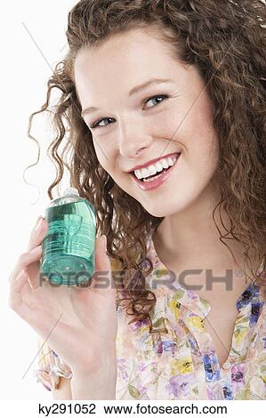 Portrait of a woman holding a bottle of aromatherapy oil View Large Photo Image Stock Image - Portrait of a woman holding a bottle of aromatherapy oil. Fotosearch