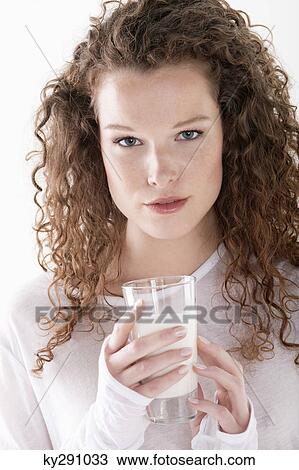 Portrait of a woman holding a glass of milk View Large Photo Image Stock Image - Portrait of a woman holding a glass of milk. Fotosearch