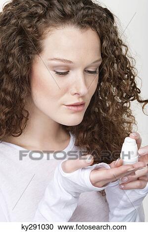 Woman pouring moisturizer on her palm View Large Photo Image Stock Image - Woman pouring moisturizer on her palm. Fotosearch