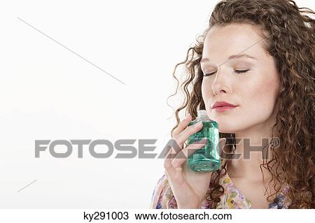 Woman smelling aromatherapy oil View Large Photo Image Stock Image - Woman smelling aromatherapy oil. Fotosearch