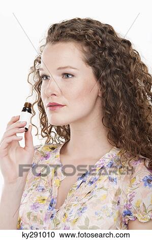 Woman smelling aromatherapy oil View Large Photo Image Stock Image - Woman smelling aromatherapy oil. Fotosearch