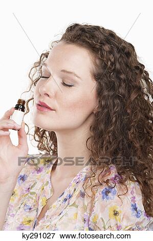 Woman smelling aromatherapy oil View Large Photo Image Stock Photo - Woman smelling aromatherapy oil. Fotosearch