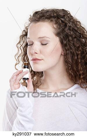 Woman smelling aromatherapy oil View Large Photo Image Stock Photo - Woman smelling aromatherapy oil. Fotosearch