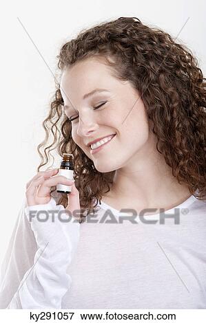 Woman smelling aromatherapy oil View Large Photo Image Stock Photo - Woman smelling aromatherapy oil. Fotosearch