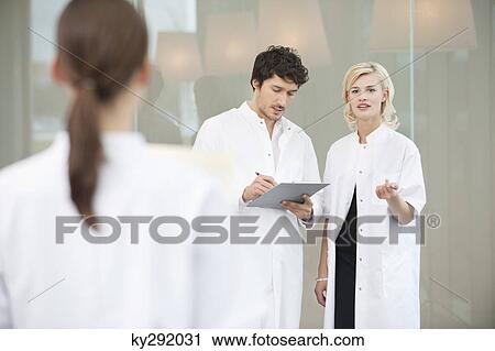 Doctor discussing with her colleague View Large Photo Image Stock Image - Doctor discussing with her colleague. Fotosearch