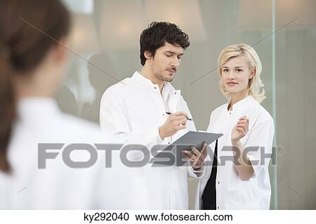 Doctor discussing with her colleague View Large Photo Image Stock Image - Doctor discussing with her colleague. Fotosearch