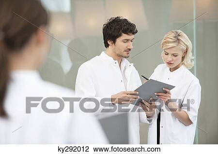 Stock Image - Doctors discussing a medical report. Fotosearch