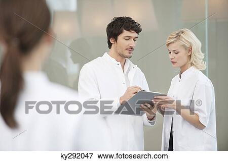 Stock Photo - Doctors discussing a medical report. Fotosearch