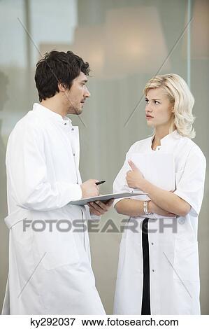Doctors examining a medical report View Large Photo Image Stock Photo - Doctors examining a medical report. Fotosearch
