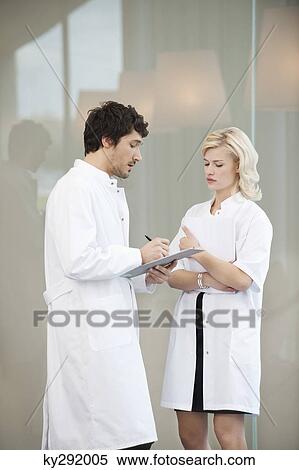 Stock Photography - Doctors examining a medical report. Fotosearch