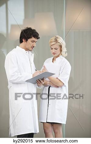 Doctors examining a medical report View Large Photo Image Stock Photography - Doctors examining a medical report. Fotosearch