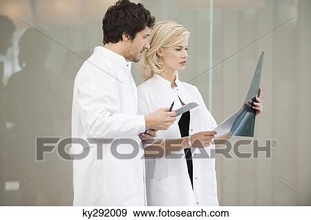 Stock Photo - Doctors examining an x-ray report. Fotosearch