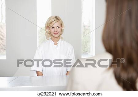 Female nurse looking at a woman View Large Photo Image Stock Image - Female nurse looking at a woman. Fotosearch