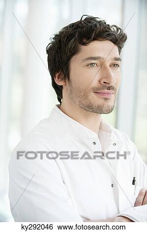 Male doctor standing with his arms crossed View Large Photo Image Stock Photograph - Male doctor standing with his arms crossed. Fotosearch