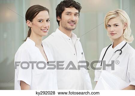 Stock Photo - Portrait of three doctors smiling. Fotosearch