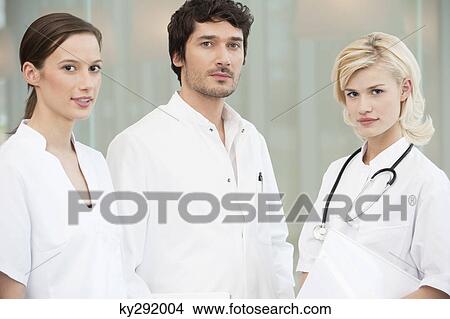 Portrait of three doctors standing together View Large Photo Image Picture - Portrait of three doctors standing together. Fotosearch