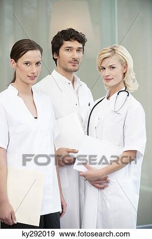 Stock Photo - Portrait of three doctors standing together. Fotosearch
