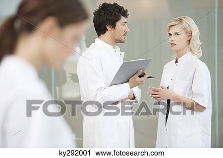 Two doctors discussing each other View Large Photo Image Stock Image - Two doctors discussing each other. Fotosearch