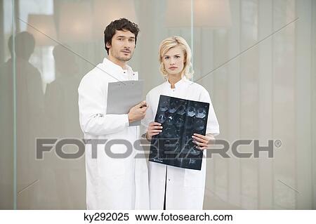 Two doctors standing together View Large Photo Image Stock Photography - Two doctors standing together. Fotosearch
