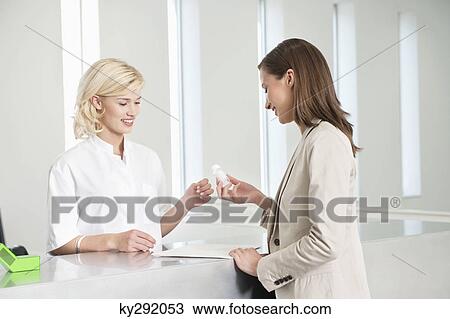 Woman analyzing a pill bottle View Large Photo Image Stock Image - Woman analyzing a pill bottle. Fotosearch