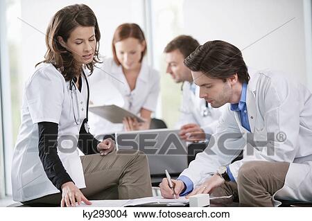 Doctors discussing together View Large Photo Image Picture - Doctors discussing together. Fotosearch