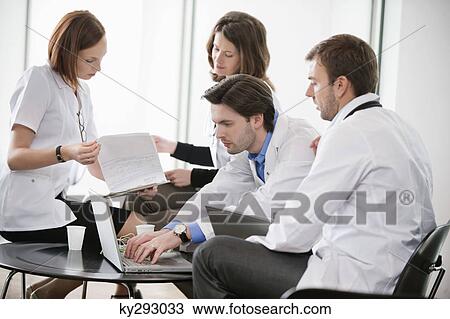 Doctors discussing together View Large Photo Image Stock Image - Doctors discussing together. Fotosearch