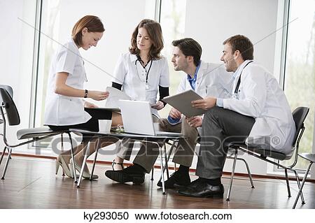 Stock Image - Doctors discussing together. Fotosearch