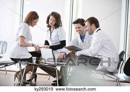 Stock Photo - Doctors discussing together. Fotosearch