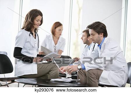 Stock Photograph - Doctors discussing together. Fotosearch