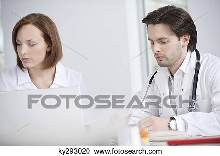 Doctors working in an office View Large Photo Image Stock Image - Doctors working in an office. Fotosearch