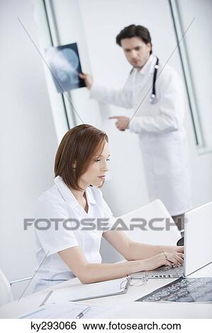 Doctors working in an office View Large Photo Image Stock Photograph - Doctors working in an office. Fotosearch