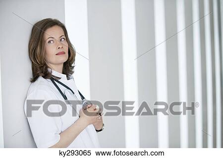 Female doctor day dreaming View Large Photo Image Stock Photography - Female doctor day dreaming. Fotosearch