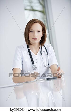 Female doctor working in an office View Large Photo Image Picture - Female doctor working in an office. Fotosearch